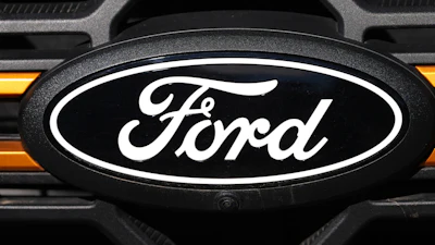 Ford logo on vehicle grille with black and white oval emblem