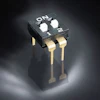 Black DIP switch with two gold pins and ON/1/2 position markings