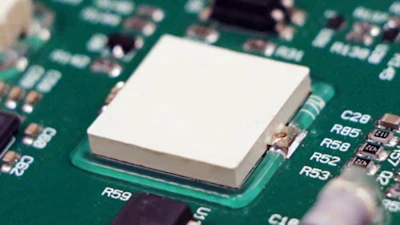 White heat sink mounted on green computer circuit board with electronic components