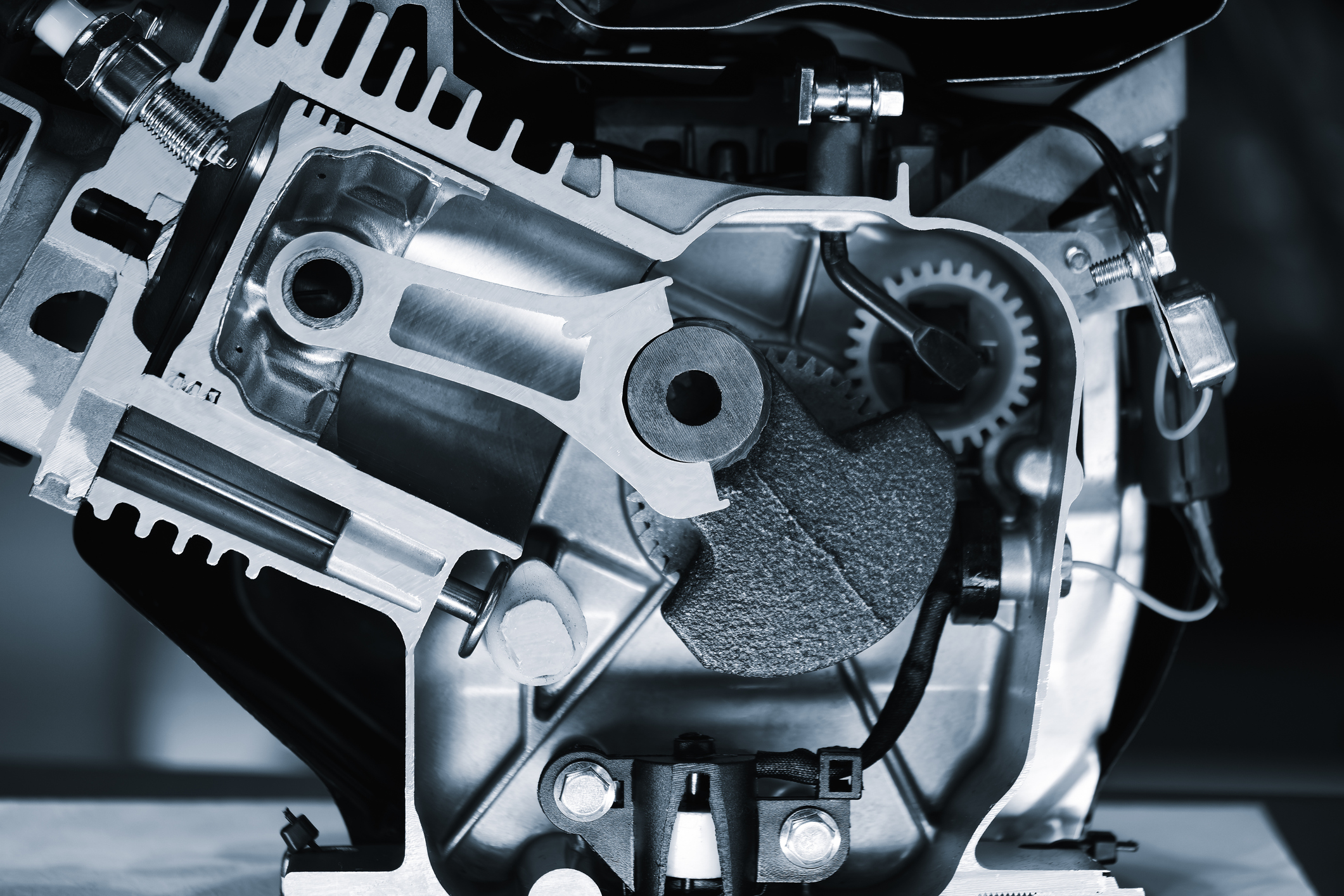 Cross-sectional view of internal combustion engine showing pistons, gears, cylinders, and metal mechanical components