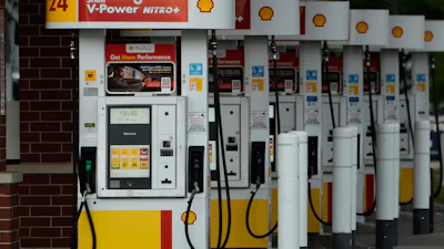 Row of Shell V-Power Nitro+ fuel pumps at a gas station with yellow and red pump bases