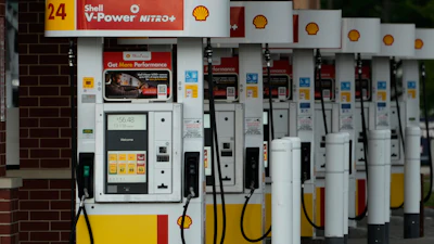 Row of Shell V-Power Nitro+ fuel pumps at gas station with yellow and red accents