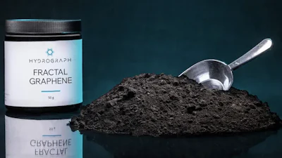 Hydrograph Fractal Graphene powder in white jar with metal scoop on dark teal background