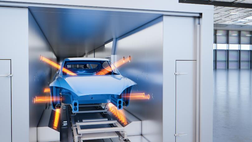 Blue car on conveyor system in automated car wash facility with glowing orange lights