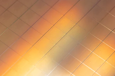 Abstract orange and yellow gradient background with diagonal grid pattern overlay