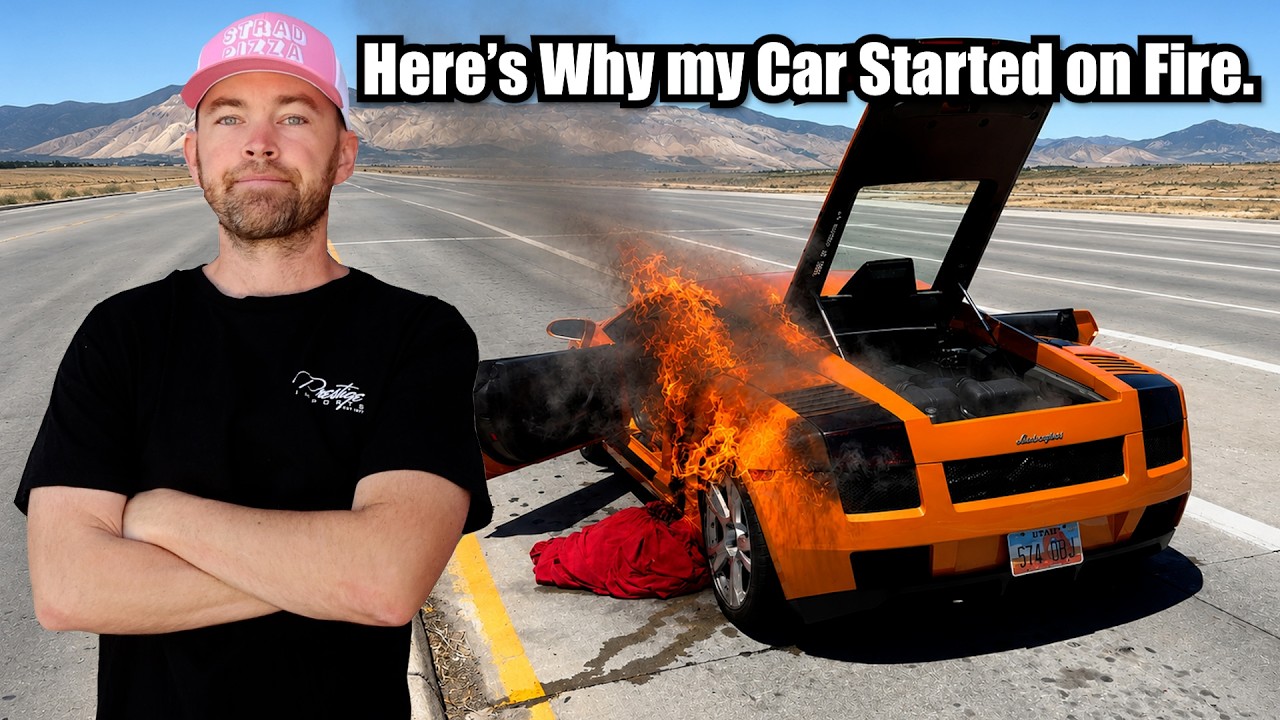 Man in pink cap posing next to burning orange sports car on desert highway with mountains in background