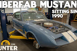 Blue and white Fiberfab Mustang kit car with open hood on lift in workshop, sitting since 1990