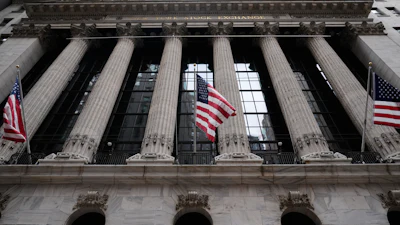 New York Stock Exchange building facade with classical columns and American flags