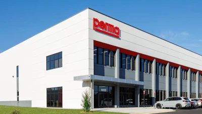 Modern white industrial building with red Perma logo signage and blue-gray architectural elements