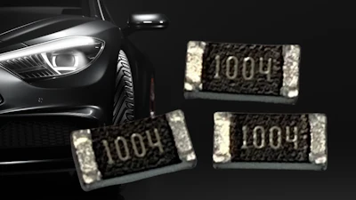 Luxury vehicle headlight with surface-mount resistor components marked 1004 displayed against dark background