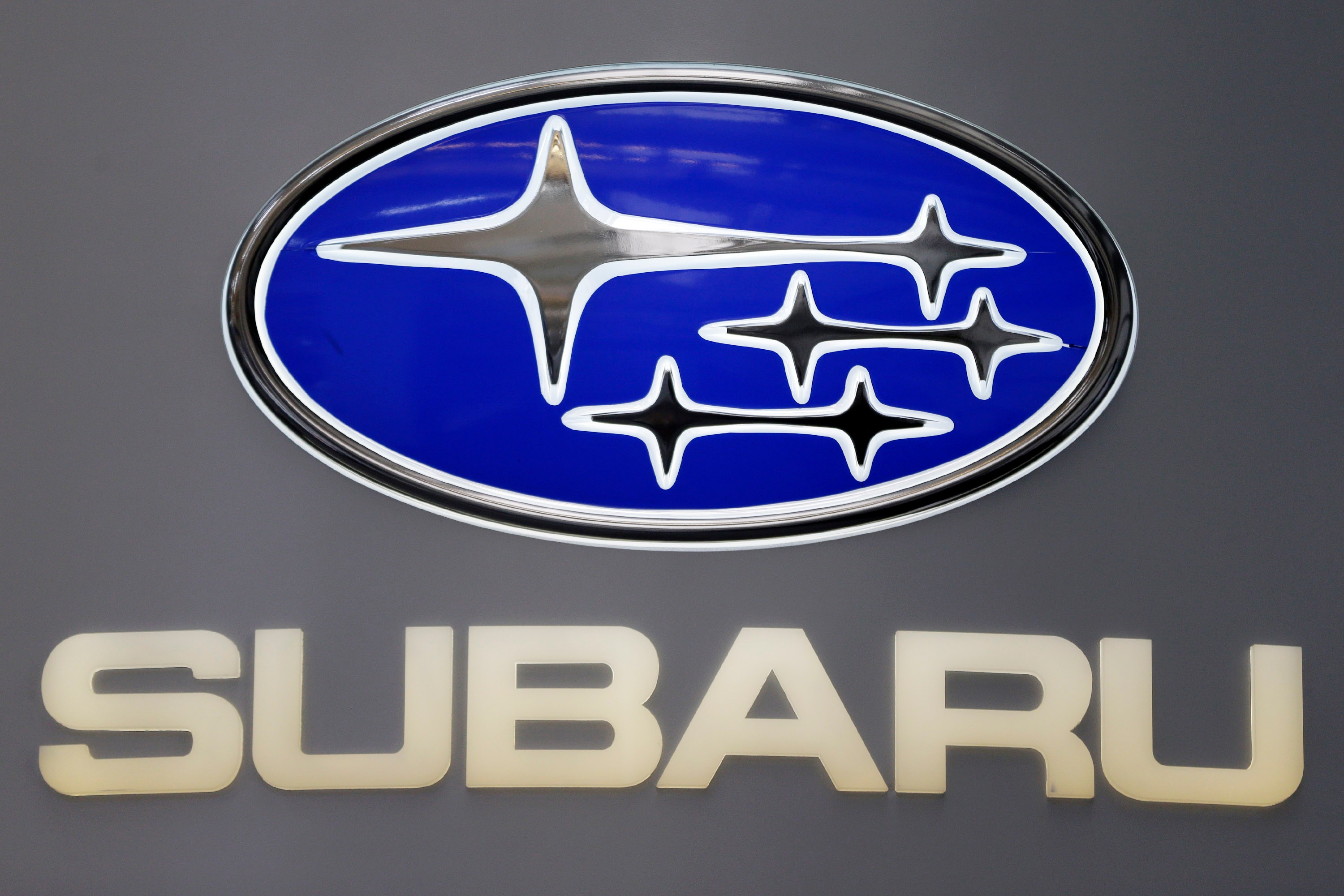 Subaru logo featuring blue oval badge with white star symbols and beige text