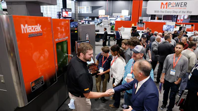 Mazak industrial machinery exhibition with visitors and staff at trade show booth