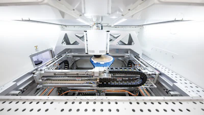 Interior view of automated laboratory analyzer with mechanical components, tracks, and robotic arm system