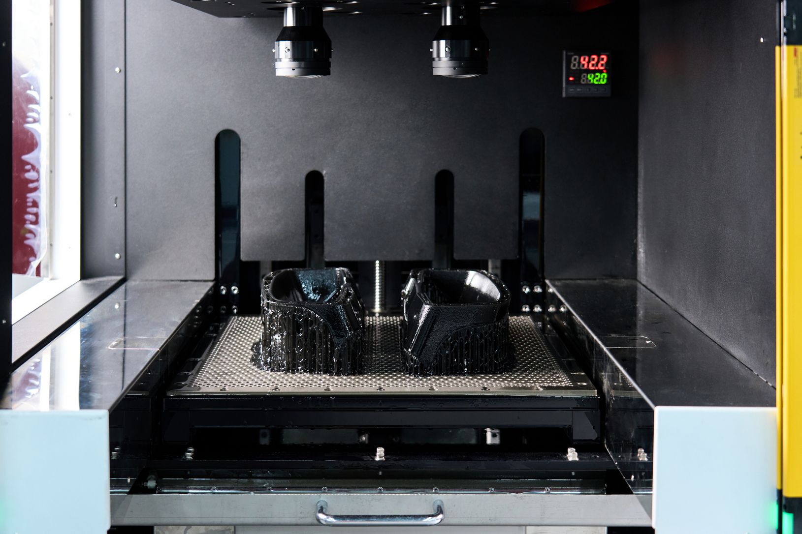 Interior view of commercial oven or sterilizer with metal racks and digital temperature display