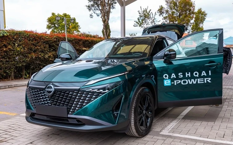 Teal Nissan Qashqai e-POWER electric vehicle with open door in parking lot