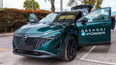 Teal Nissan Qashqai e-POWER electric vehicle with open door in parking lot