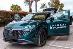 Teal Nissan Qashqai e-POWER electric vehicle with open door in parking lot