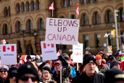 Signs at a rally on Parliament Hill in Ottawa, March 9, 2025.