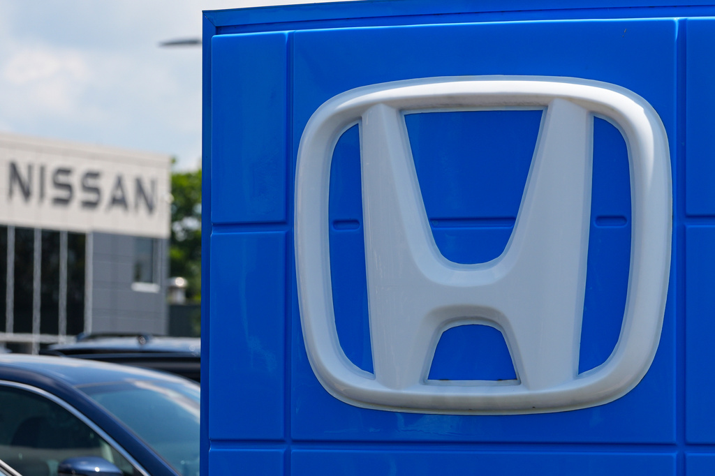 Honda dealership storefront with silver H-logo on blue signage panel