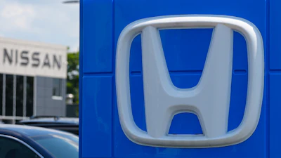Honda dealership storefront with silver H-logo on blue signage panel