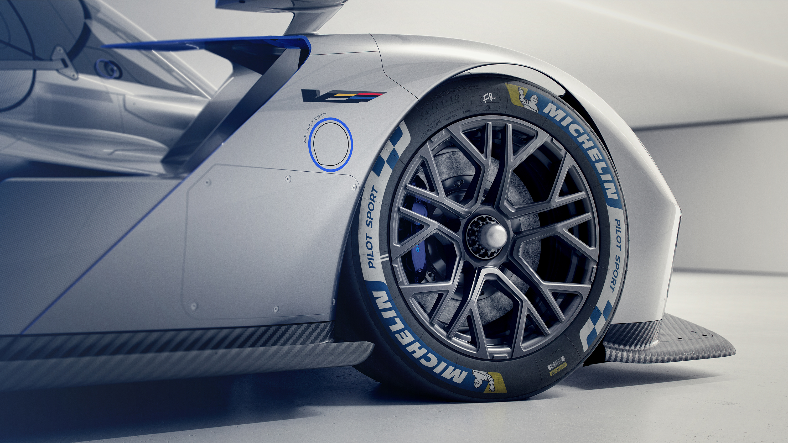 White race car with blue accents displaying Michelin performance tire in detailed side view