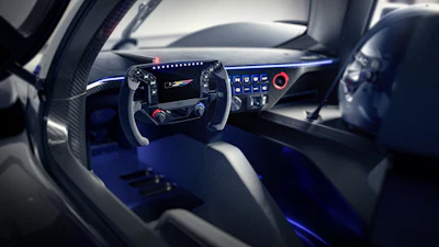 Futuristic sports car cockpit interior with digital dashboard, blue ambient lighting, and advanced steering wheel controls