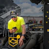 Construction worker in safety gear using Shield mobile app on smartphone at job site