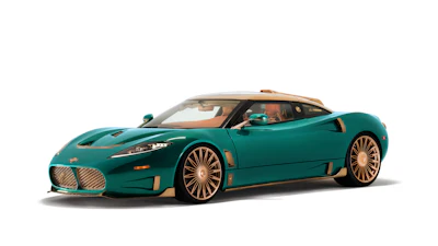 Teal and gold luxury sports car with distinctive grille and aerodynamic design on white background