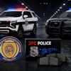 Two police SUVs with DFC Police emblems and badges displayed in urban setting with blue and red emergency lights