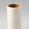 Empty cream-colored cylindrical cardboard tube with brown interior on neutral background