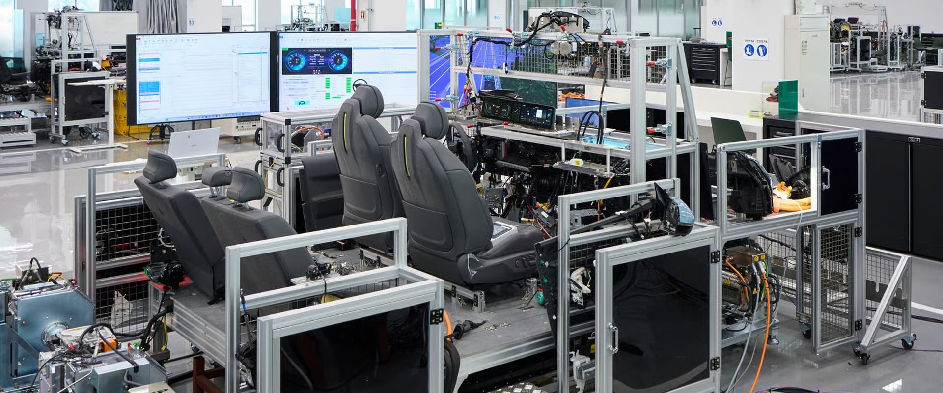 Industrial testing facility with automotive seats, computer workstations, and manufacturing equipment