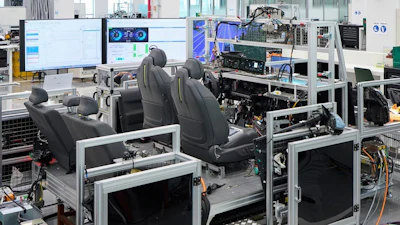 Industrial testing facility with automotive seats, computer workstations, and manufacturing equipment