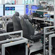 Industrial testing facility with automotive seats, computer workstations, and manufacturing equipment