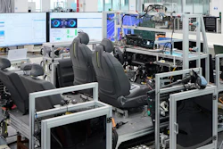 Industrial testing facility with automotive seats, computer workstations, and manufacturing equipment
