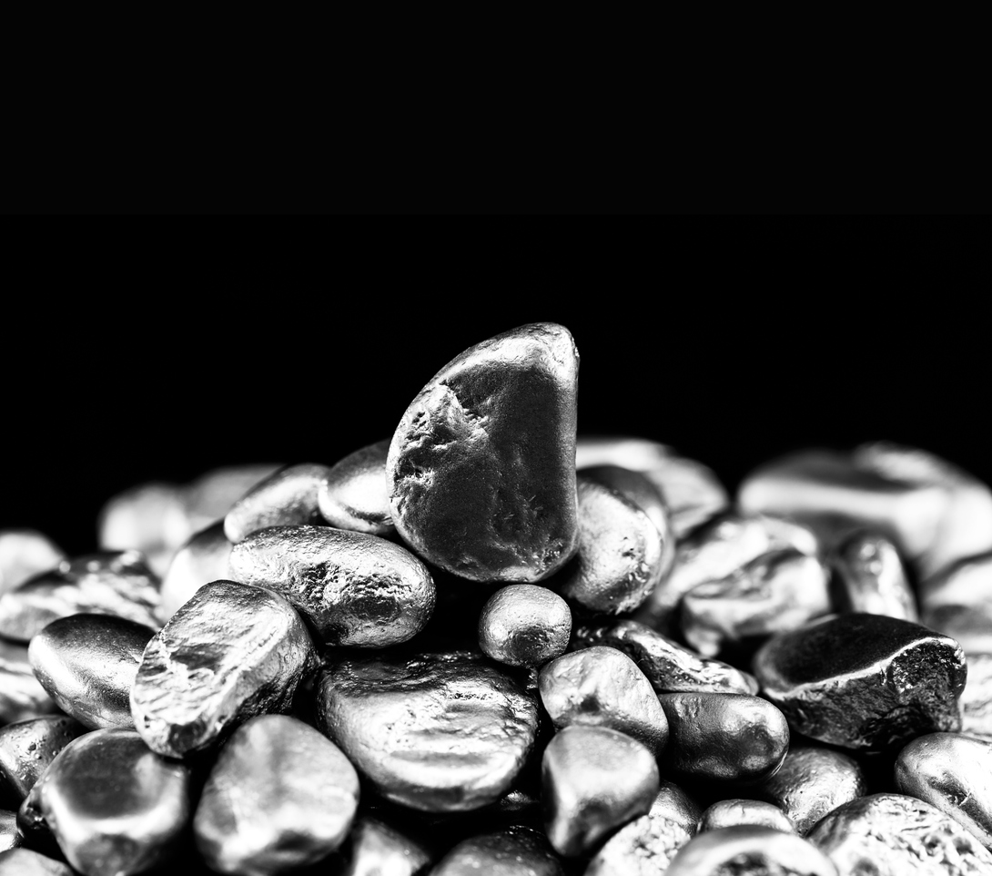 Close-up of smooth gray pebbles and stones stacked on black background