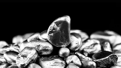 Close-up of smooth gray pebbles and stones stacked on black background