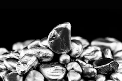 Close-up of smooth gray pebbles and stones stacked on black background