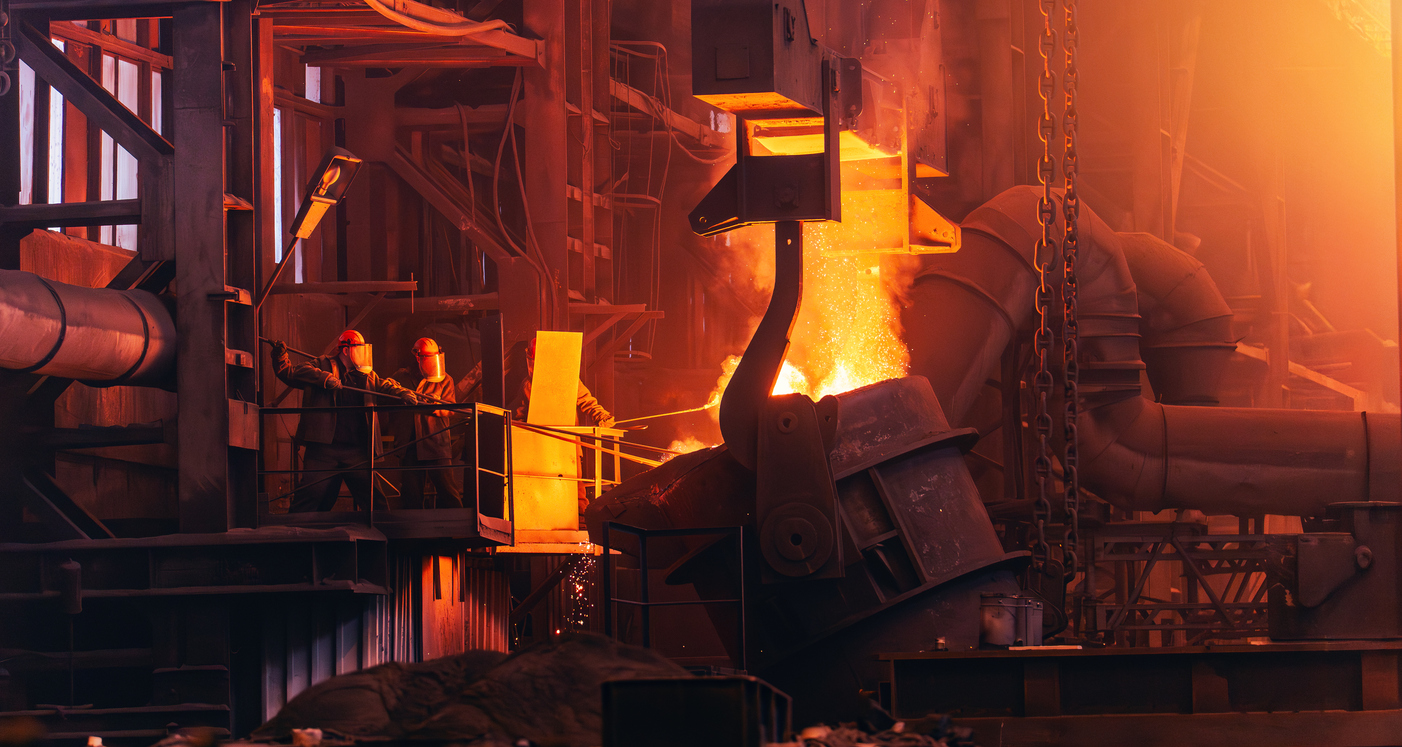 Industrial steel mill with molten metal pouring from large furnace equipment, workers on platform, intense orange glow from heat
