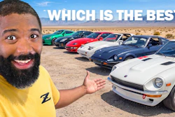 Man in yellow shirt posing with collection of sports cars lined up in desert landscape