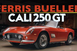 Red 1961 Ferrari 250 GT convertible sports car in showroom with classic design and white-wall tires