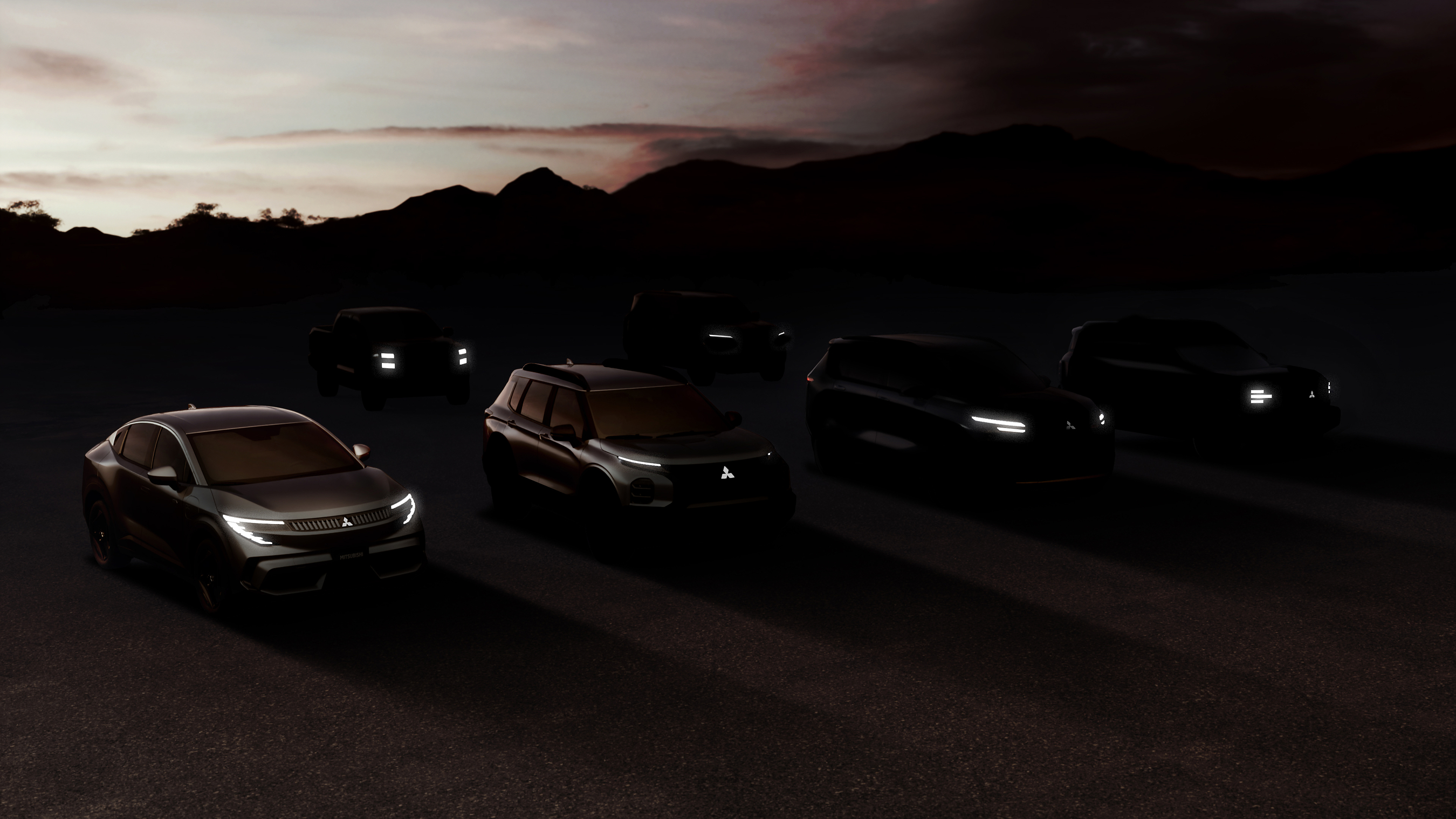 Multiple luxury vehicles parked at dusk with illuminated headlights against a mountain backdrop at sunset