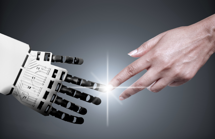 Human hand touching robotic hand with bright light between them, symbolizing AI and human collaboration