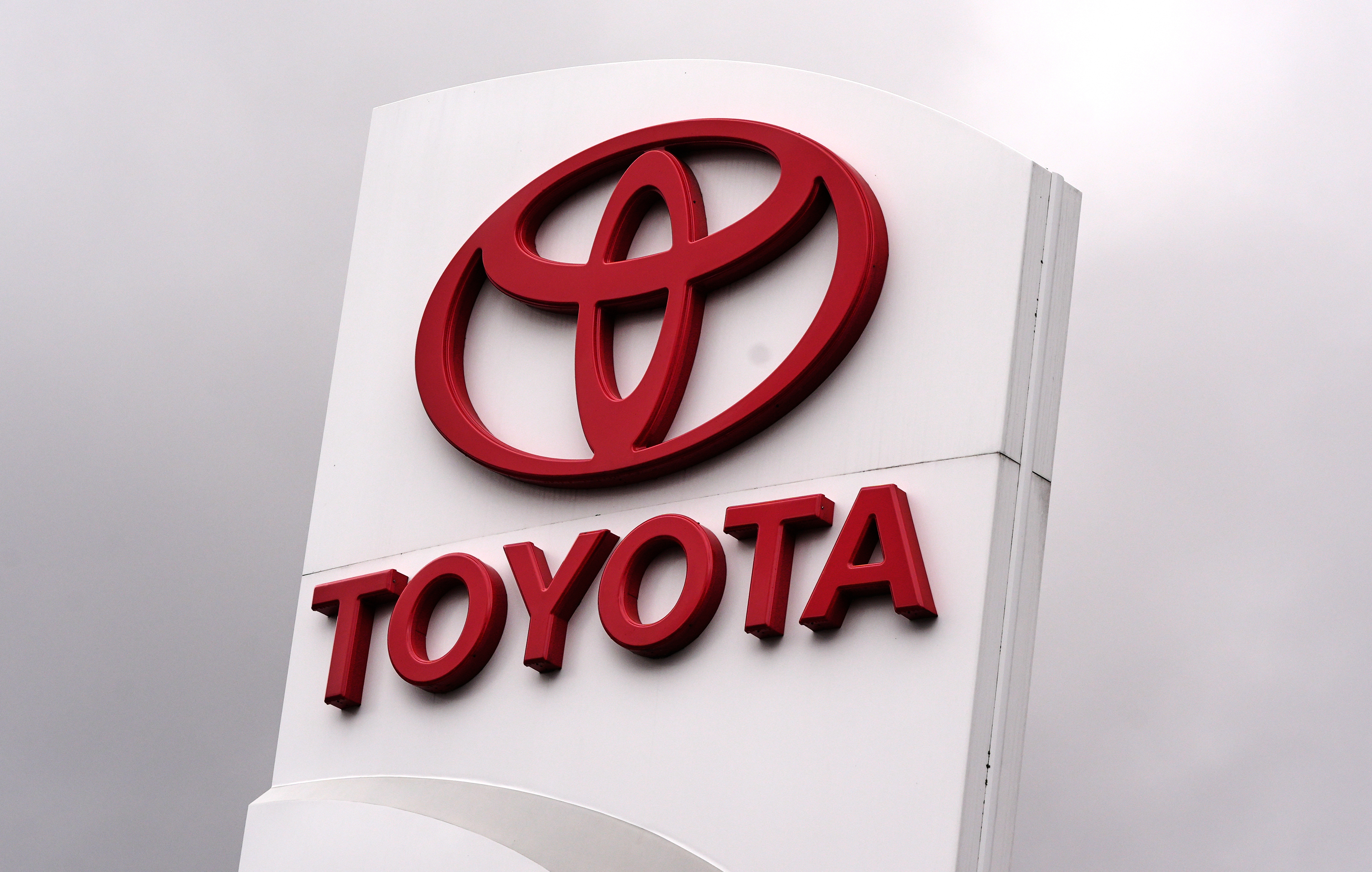 Toyota logo on red 3D signage mounted on white pillar