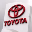 Toyota logo on red 3D signage mounted on white pillar