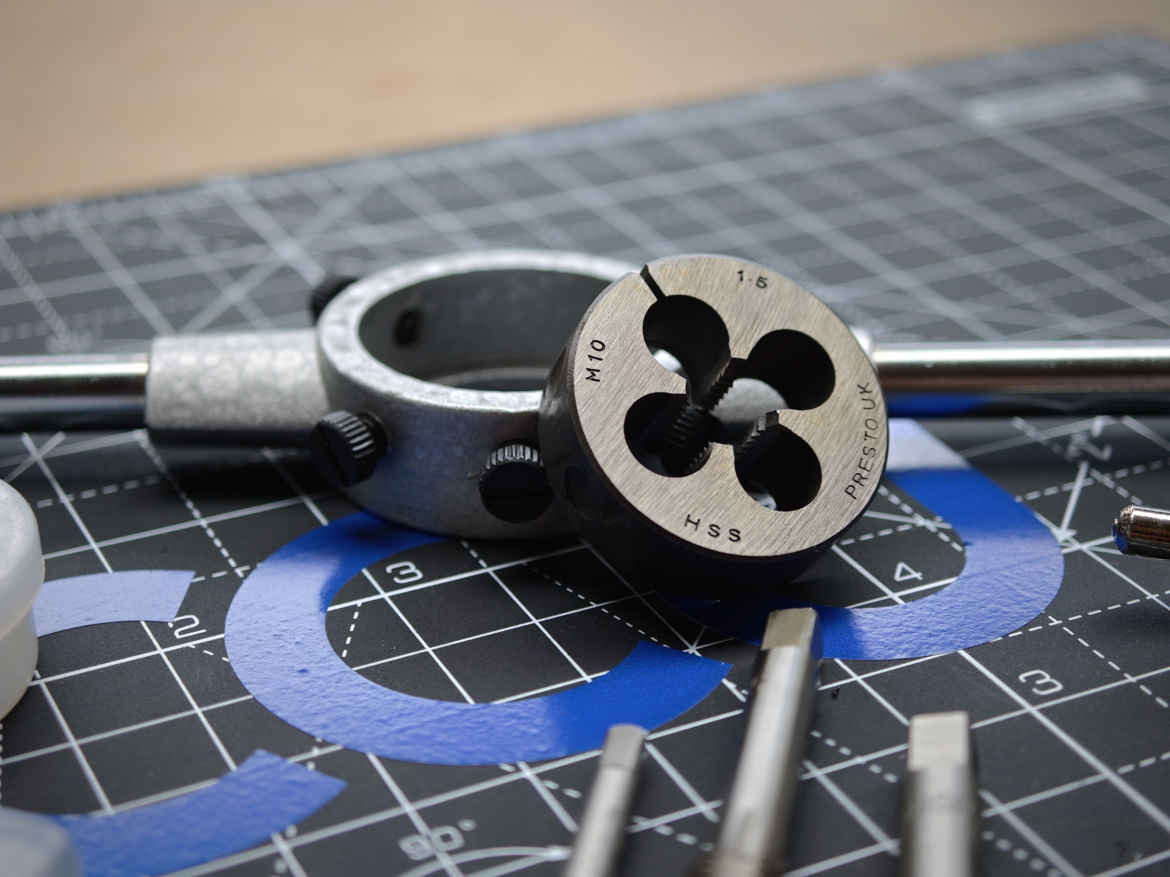 Metric thread die tool with M12 HSS marking on engineering blueprint