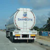 Dangote branded tanker truck on highway with palm trees and street lights