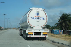 Dangote branded tanker truck on highway with palm trees and street lights