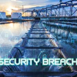 Industrial water treatment facility at sunset with digital security breach warning overlay and lock icons