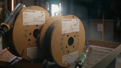 Two Fabshield fiber optic cable spools with product labels in industrial storage setting