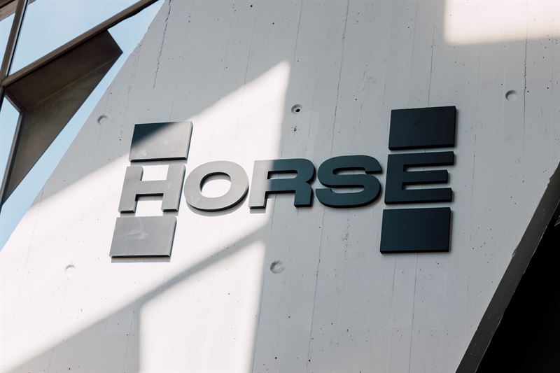 HORSE brand dimensional metal signage mounted on white concrete building exterior with geometric design elements